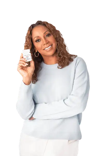 Holly Robinson
              Peete holding GEMTESA® pill bottle.